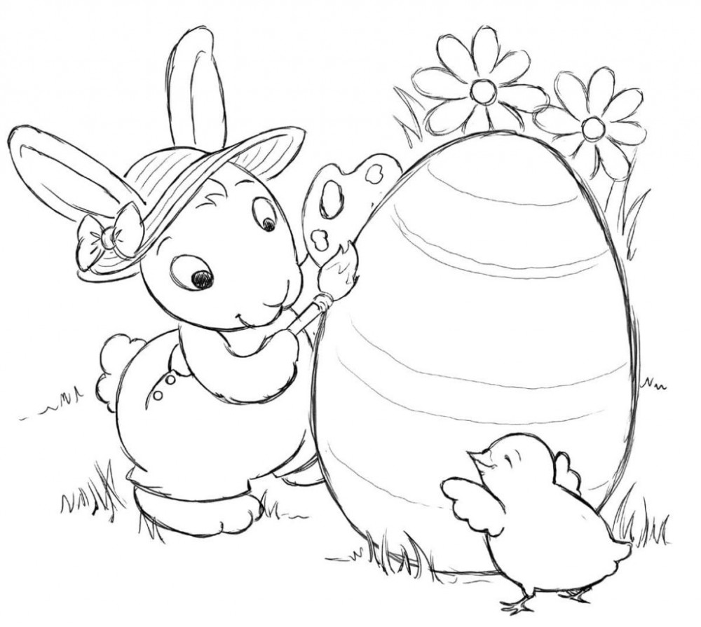 Заяц раскрашивает яйцо на Пасху